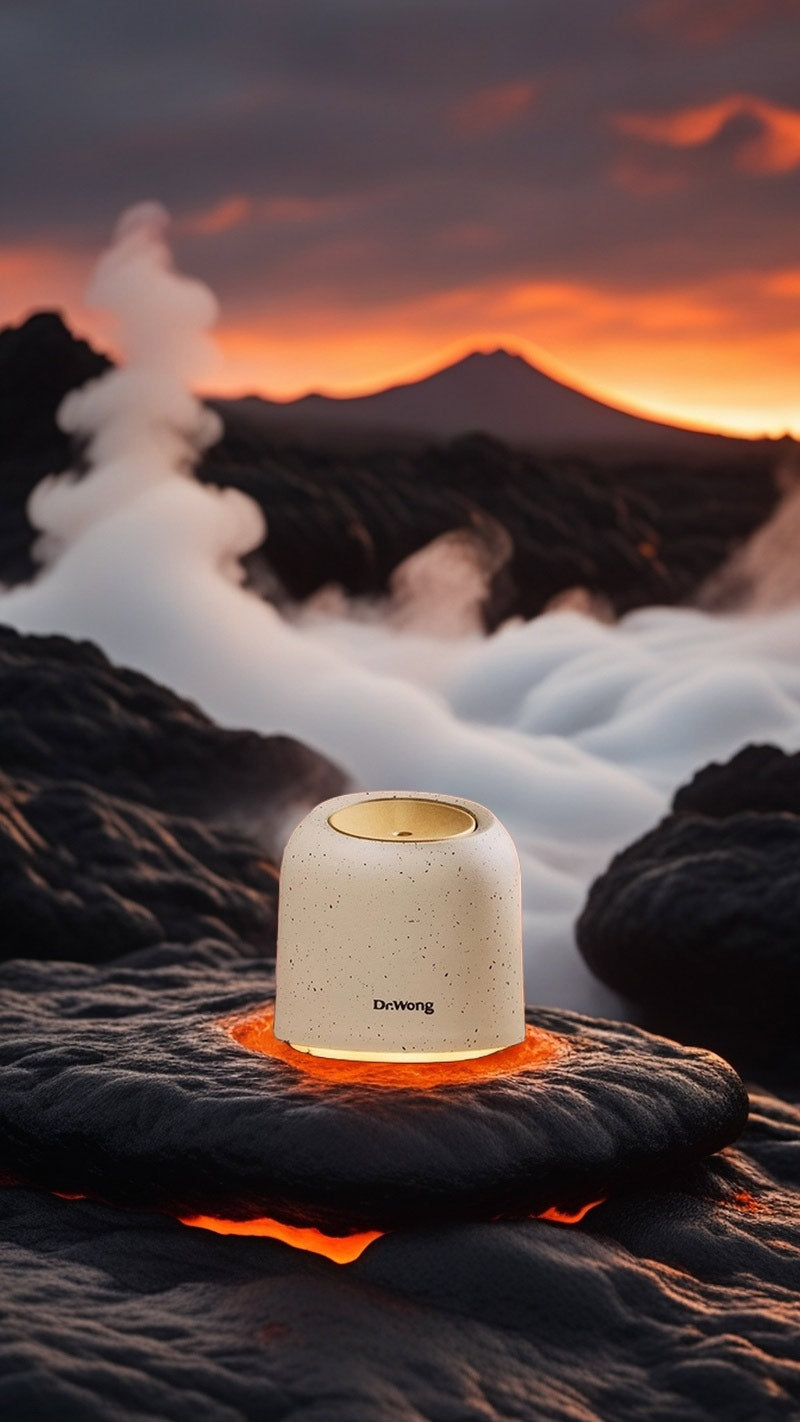 Aroma diffuser placed in a volcanic landscape setting, surrounded by textured volcanic rocks and mist, creating a raw, natural atmosphere.