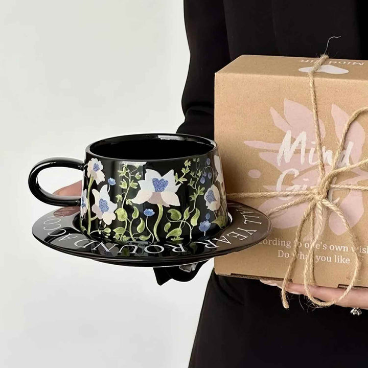 Black ceramic cup with eco-friendly gift box held by elegant woman