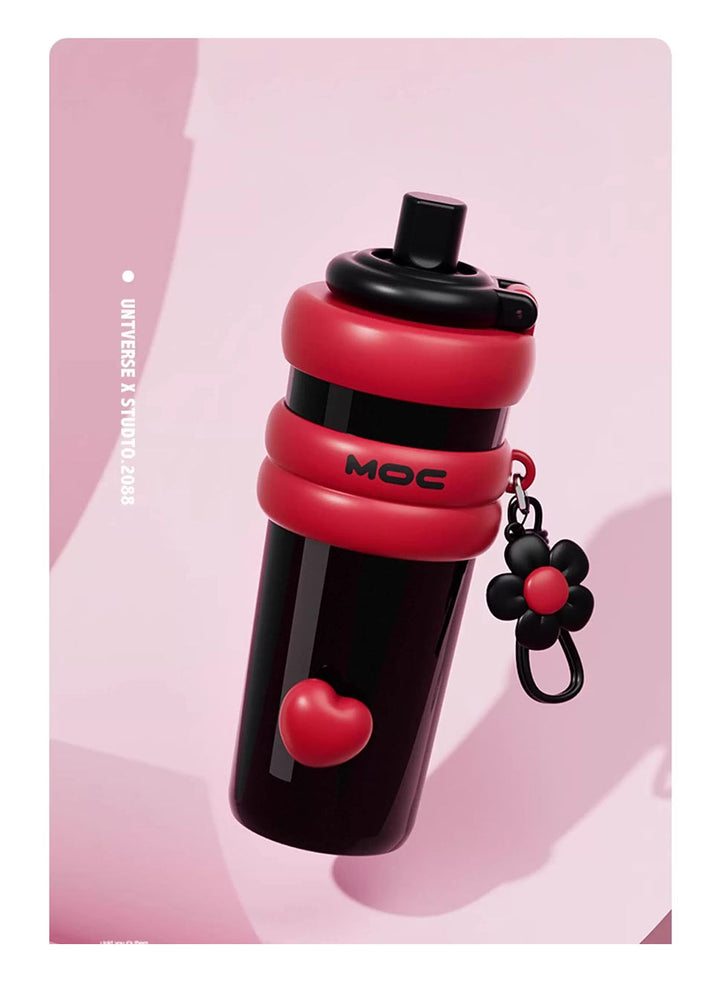MyLaEvo black bottle with red accents and heart floral pattern, symbolizing good luck on pink background