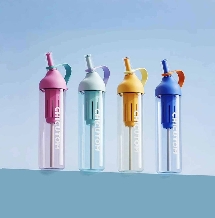 Four bottles in blue, green, yellow, and pink shown on a blue background, showcasing diverse color options.