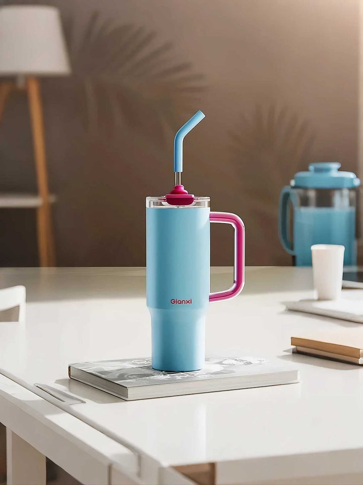Blue bottle on books with desk accessories, clean and minimal – MyLaEvo.