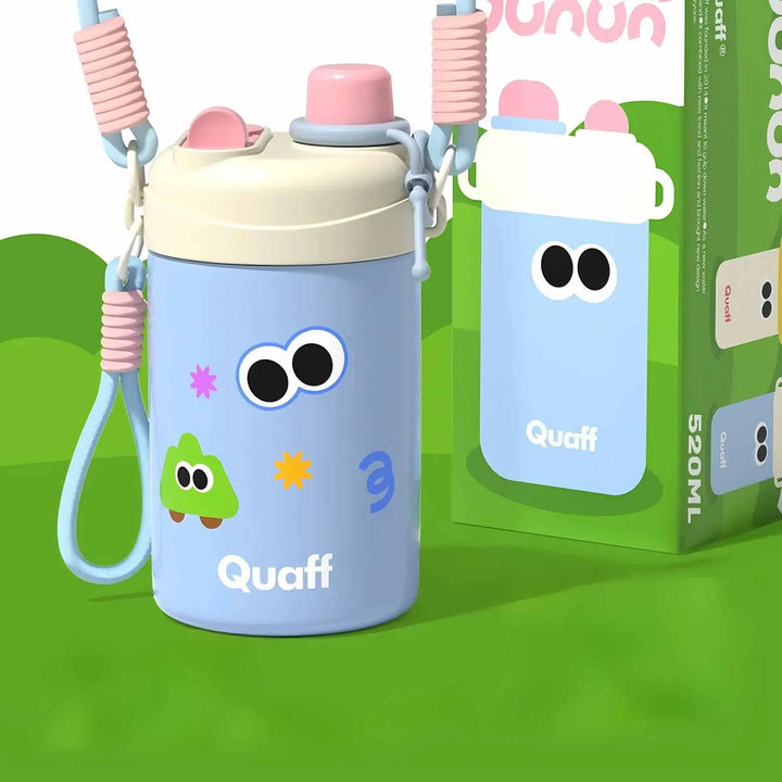 Blue insulated bottle with cream lid, pink decoration, cute sticker, and strap on green background.