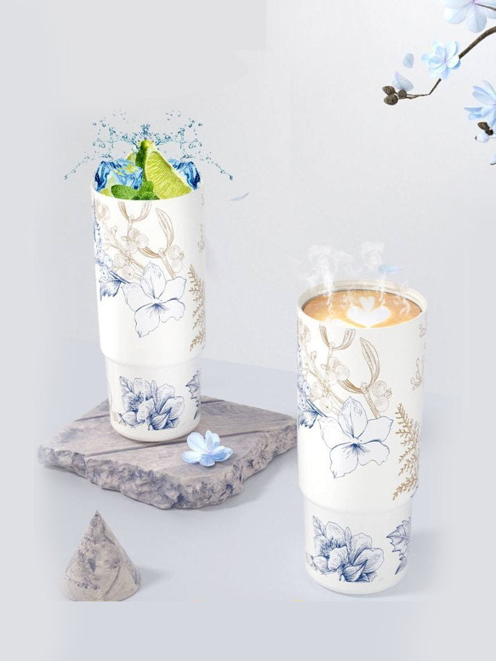Blue Lily and Mountain Flower tumblers displayed with floral accents in ambient scene – MyLaEvo.