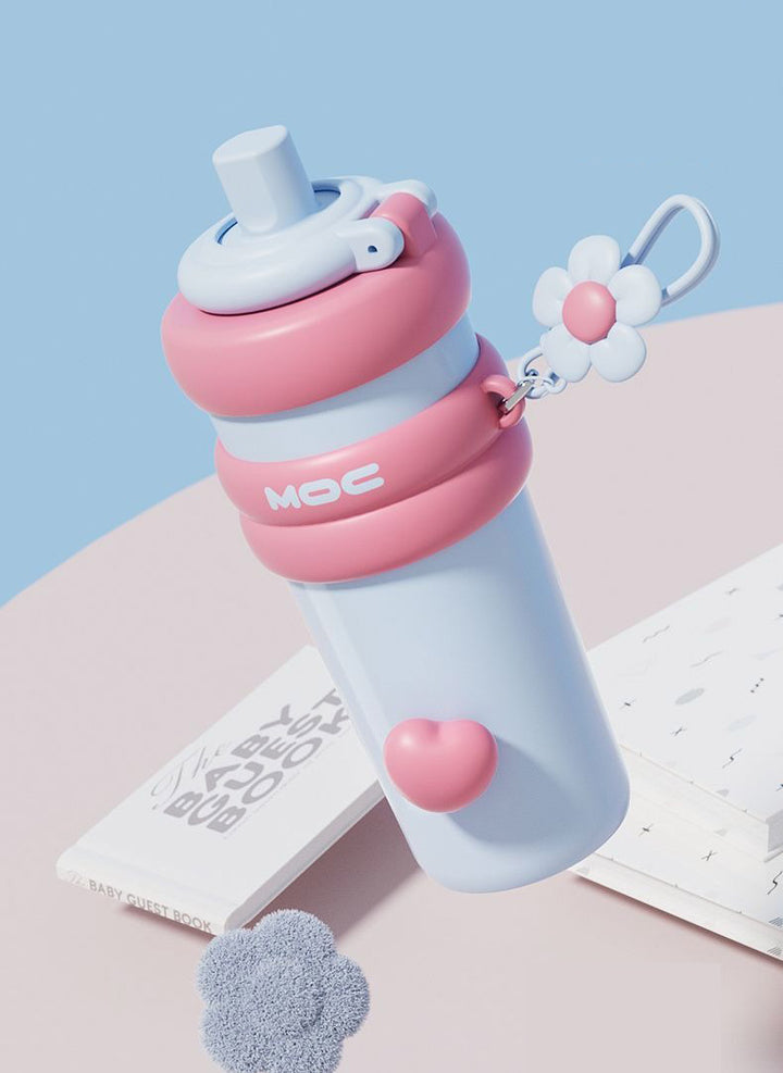 MyLaEvo light blue bottle with pink accents on pastel blue and pink desk with decor