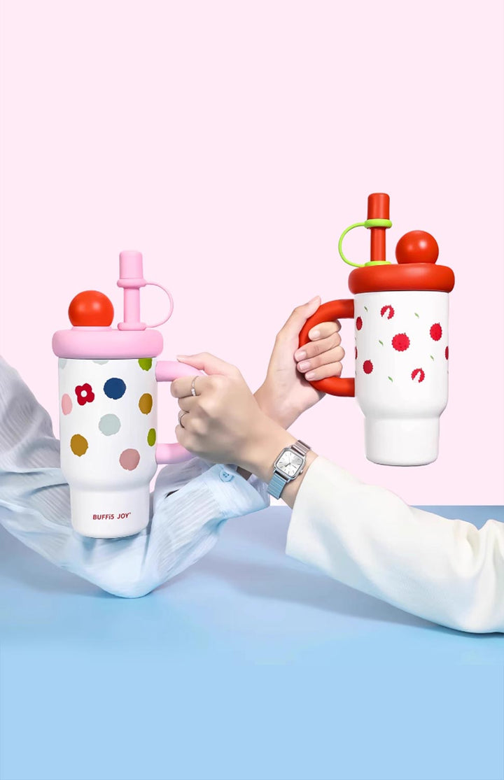 Two hands holding pink and red dopamine bottles, social and fun hydration moment