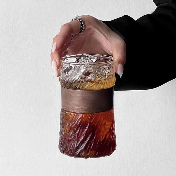 Woman gracefully holding elegant glass cup, highlighting refined and stylish modern design