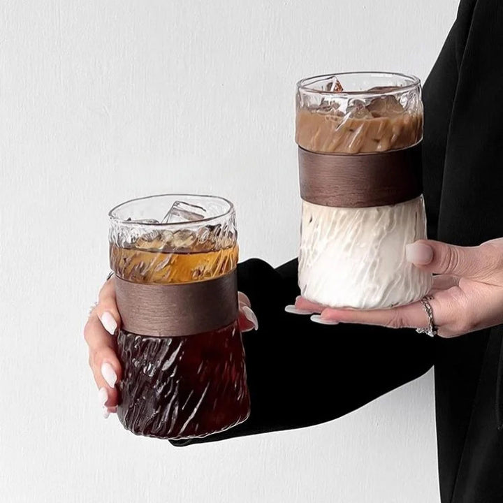 Woman holding two elegant glass cups, refined design with stylish and modern aesthetic