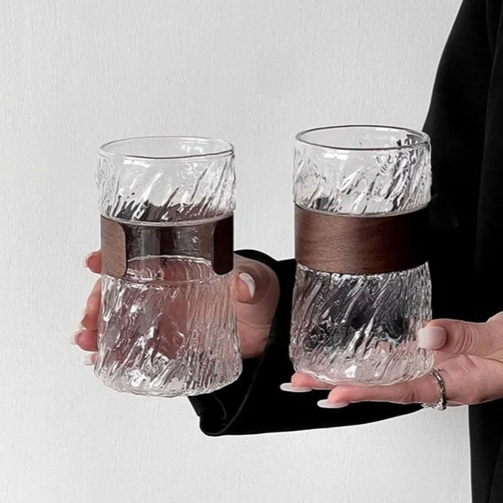 Close-up of woman gracefully holding glass cup from different angles, stylish and elegant design