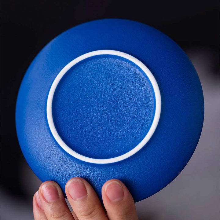 Klein blue ceramic coffee cup and saucer close-up, highlighting elegant refined craftsmanship