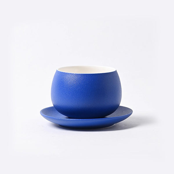 Klein blue ceramic coffee cup on white background, highlighting elegant refined high-end design