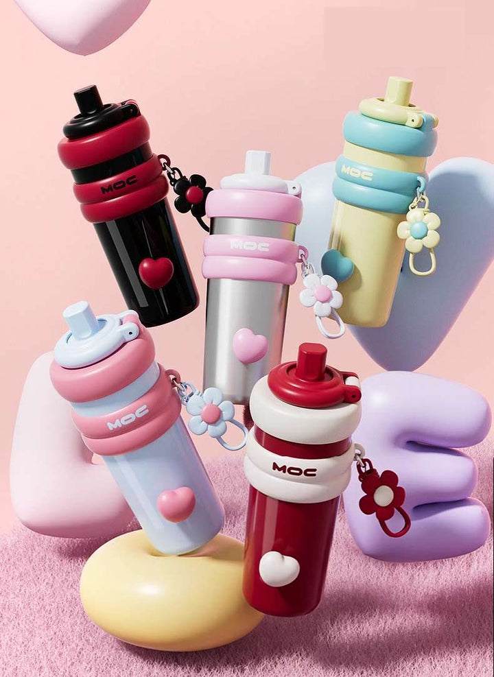 MyLaEvo bottles in black-red, natural-pink, blue-pink, yellow-blue, red-cream on pink love backdrop