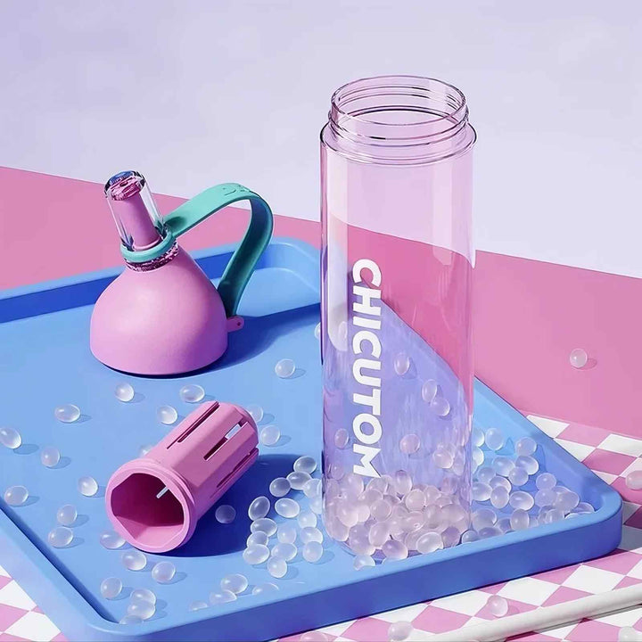Pink product displayed in parts against soft pink and blue background, highlighting design details.