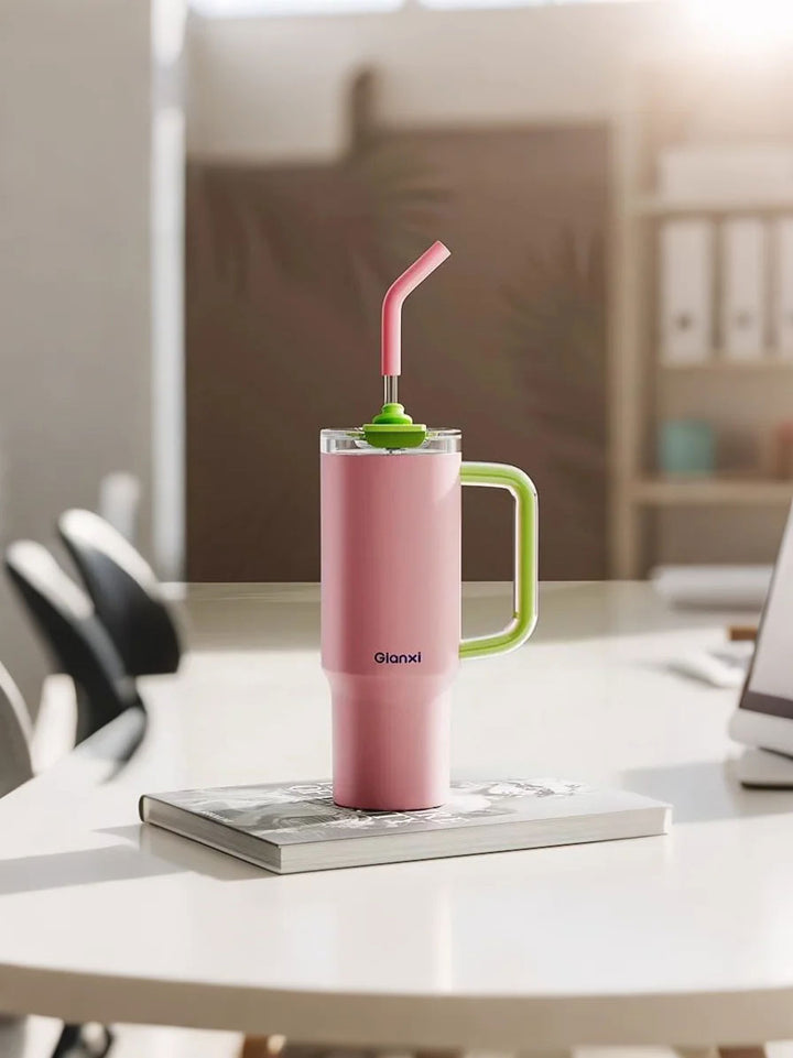 Pink tumbler on books in soft office workspace – MyLaEvo.
