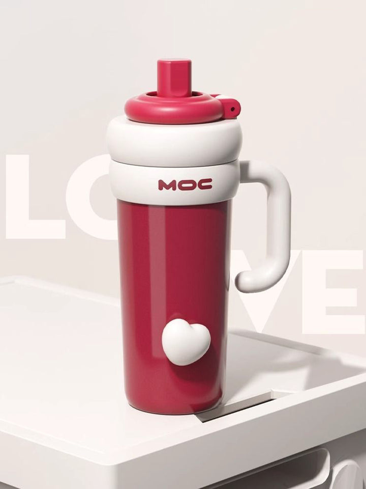 MyLaEvo red and white bottle with heart motif on white dish and clean white background