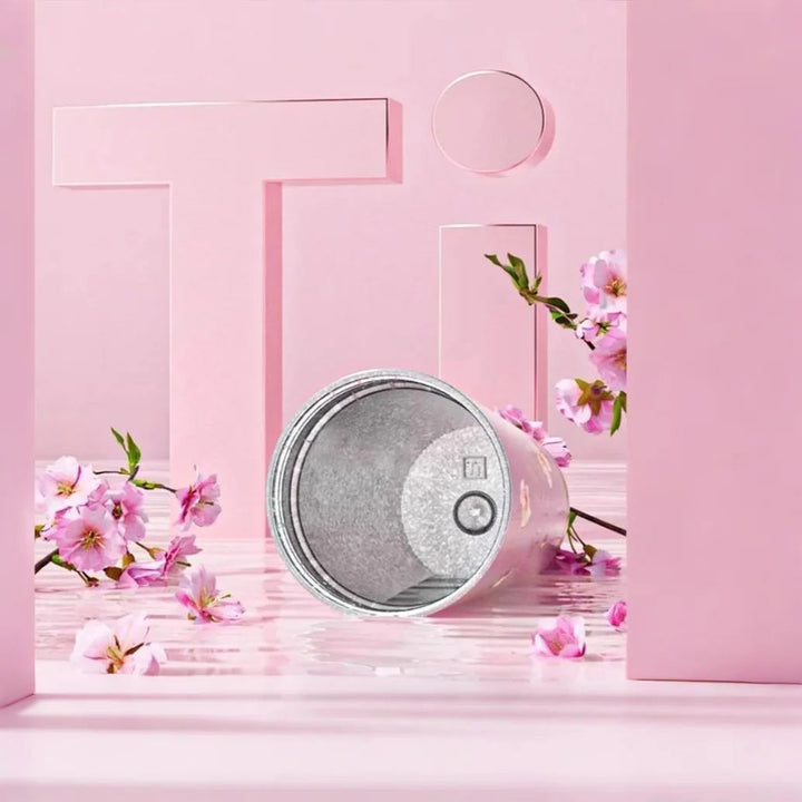 Interior of MyLaEvo titanium cup shown in pink setting with red flowers and "Ti" symbol, highlighting material quality