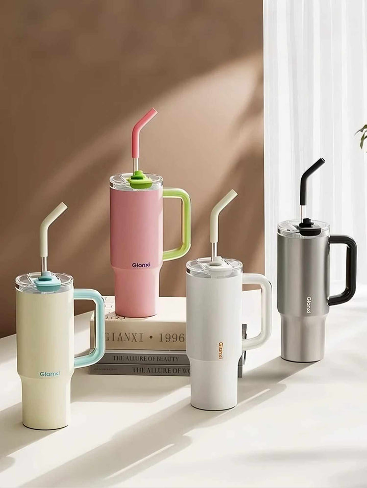 Four tumblers in pink, yellow, white, and silver on desk with books – MyLaEvo.