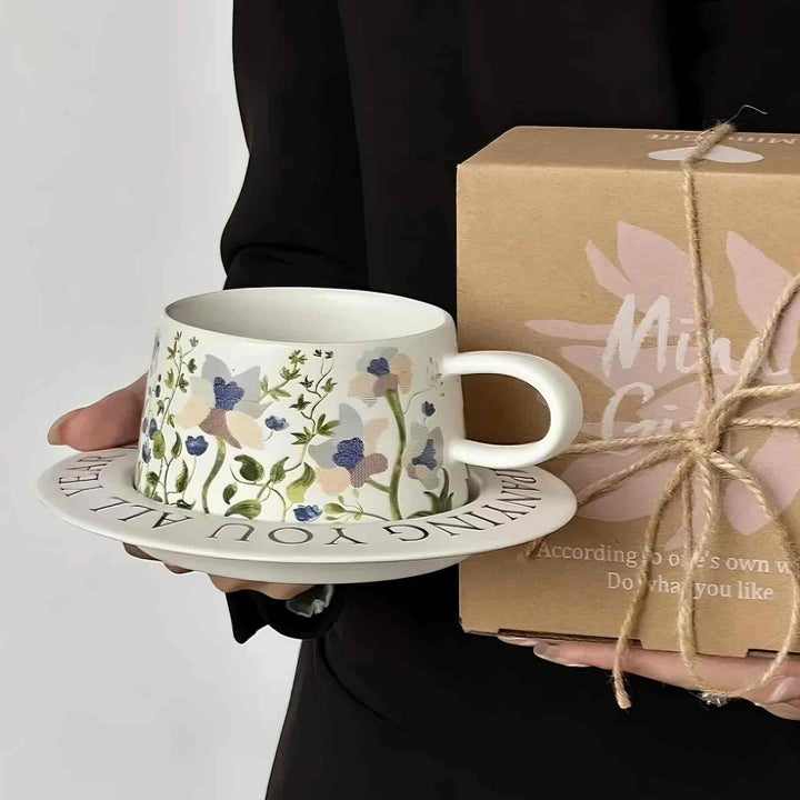 Elegant woman holding white ceramic cup with eco-friendly gift box, luxury tableware display
