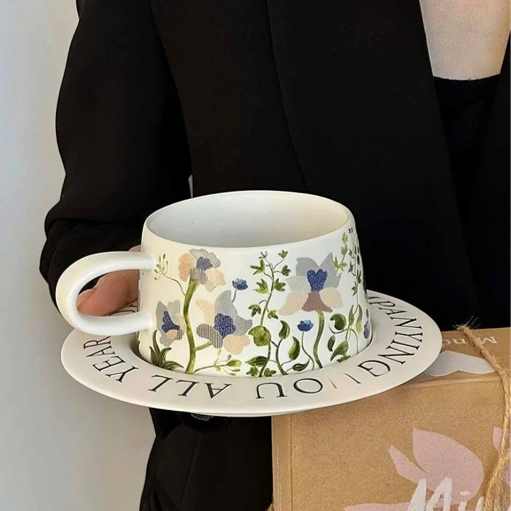 White ceramic cup with eco-friendly gift box held by woman, styled display for coffee sale