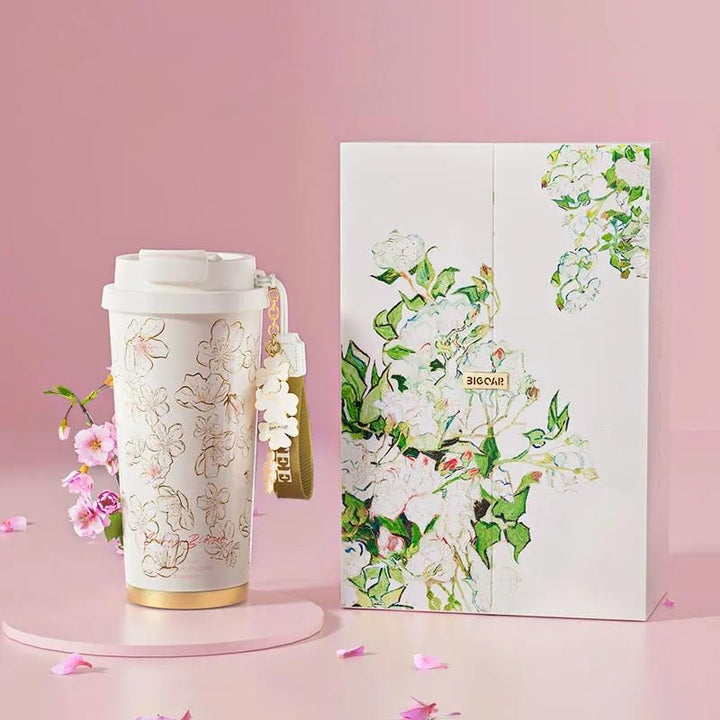 MyLaEvo pure titanium coffee cup with white sakura print and gift box, set against pink background with floral decor