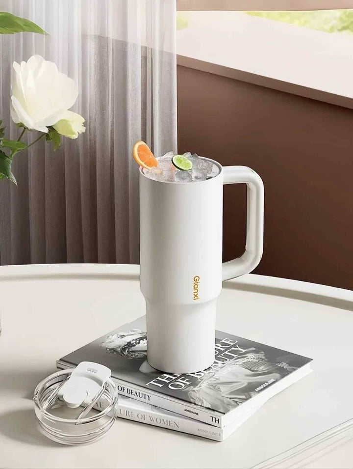 Open white tumbler with iced fruit tea, placed on books to show multipurpose use – MyLaEvo.