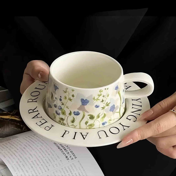 Woman holding white vintage ceramic cup over magazine in elegant space