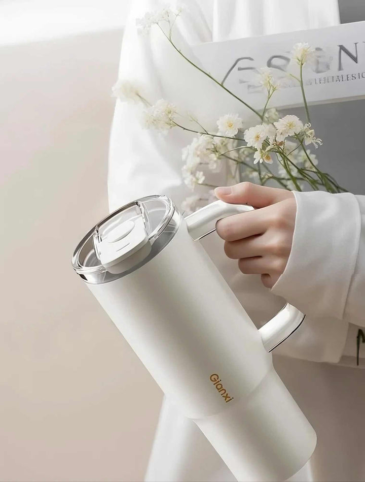 Woman holding flower bouquet and tumbler, expressing elegance and simplicity – MyLaEvo.