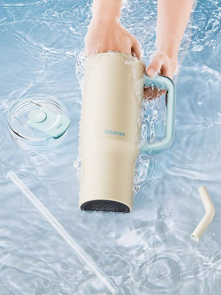 Yellow water bottle being cleaned in water, showing removable lid and straw – MyLaEvo.