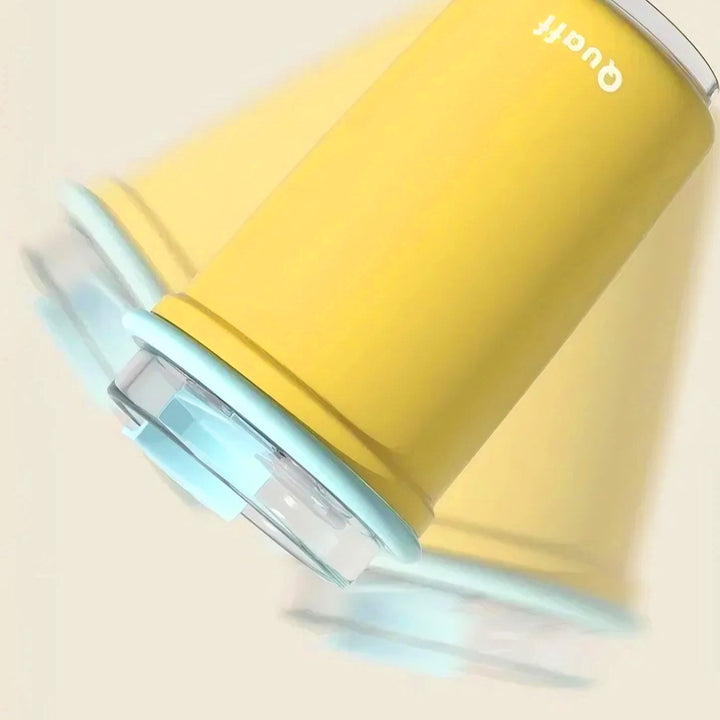 Yellow cup with blue transparent lid shown upside down shaking, demonstrating 100% leak-proof design.