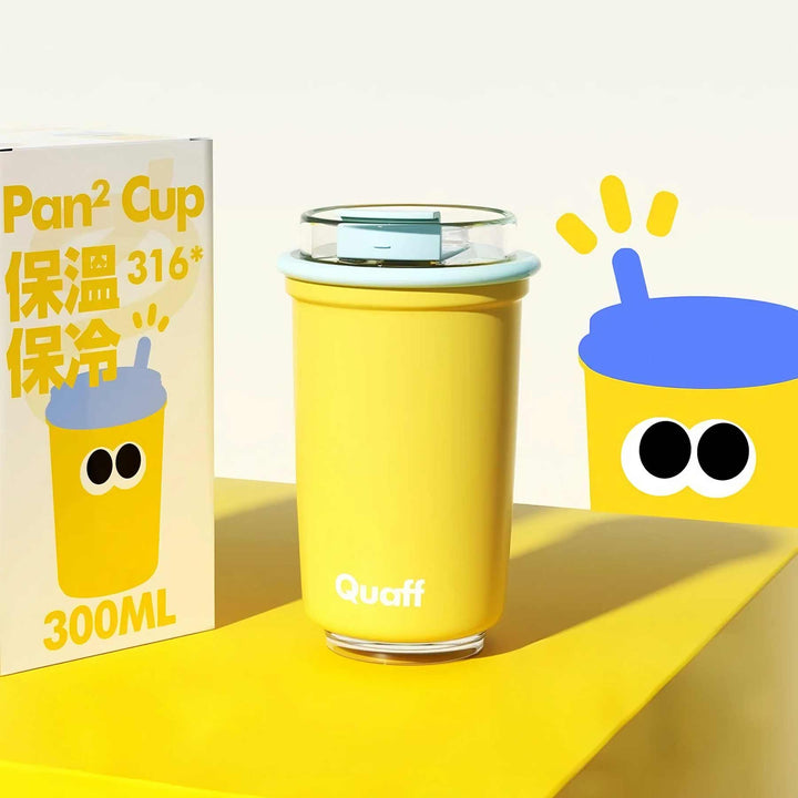 Yellow stylish cup with cute illustrated packaging on yellow surface, white backdrop, playful accents.